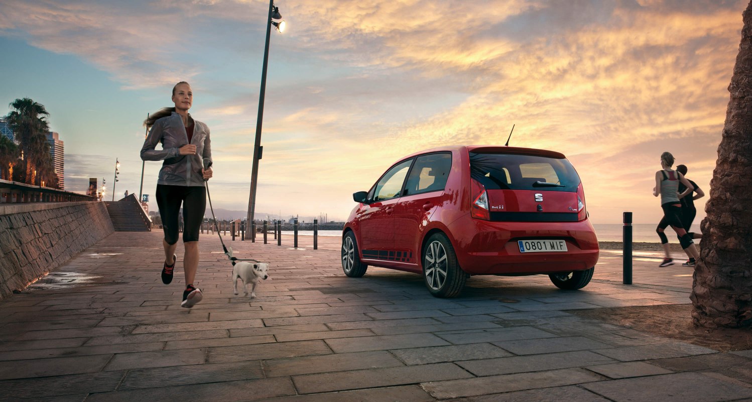 red back rear car image SEAT Mii next to Barcelona urban beach. dynamic lines and compact design