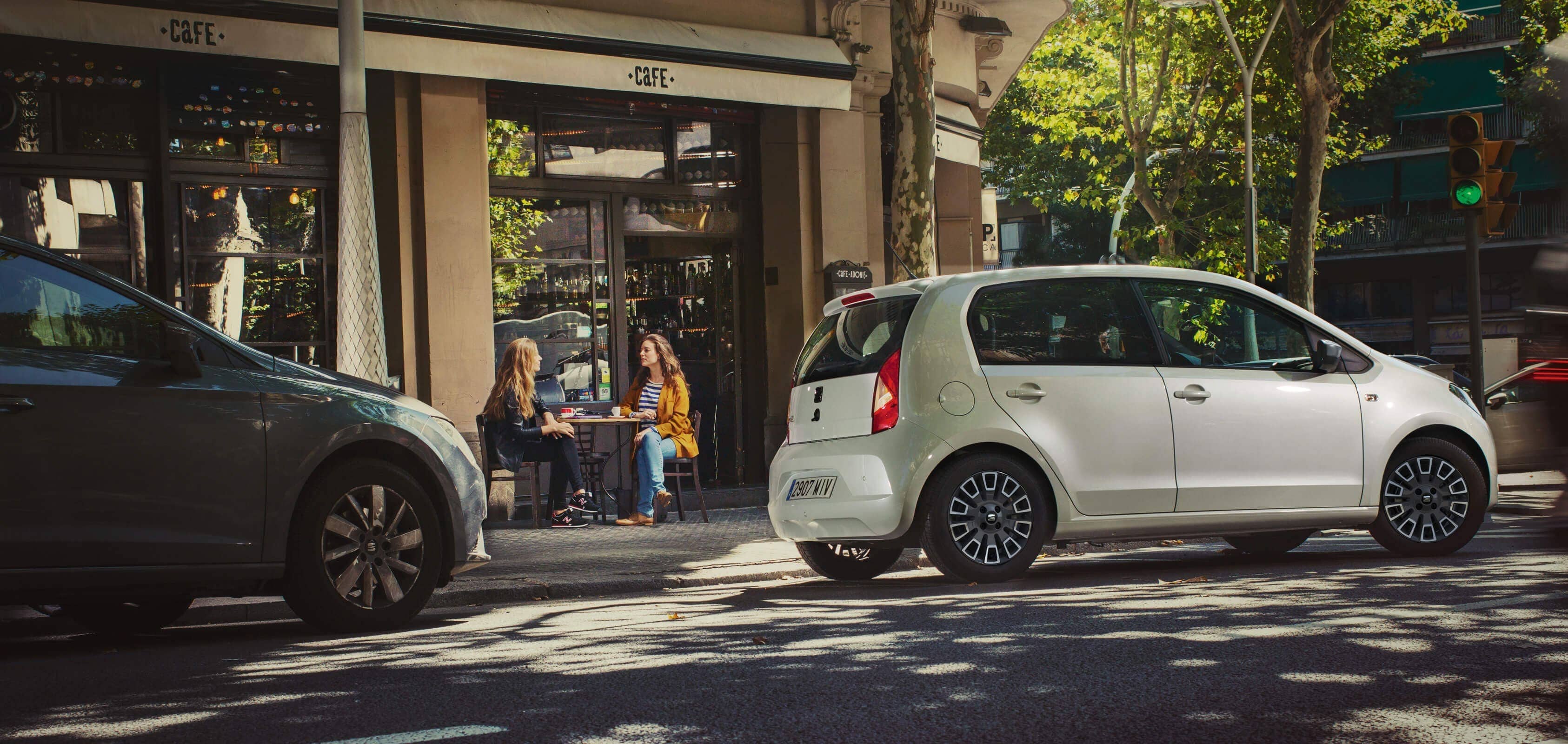 white SEAT Mii Safety. Showing a SEAT Mii on Barcelona city center.