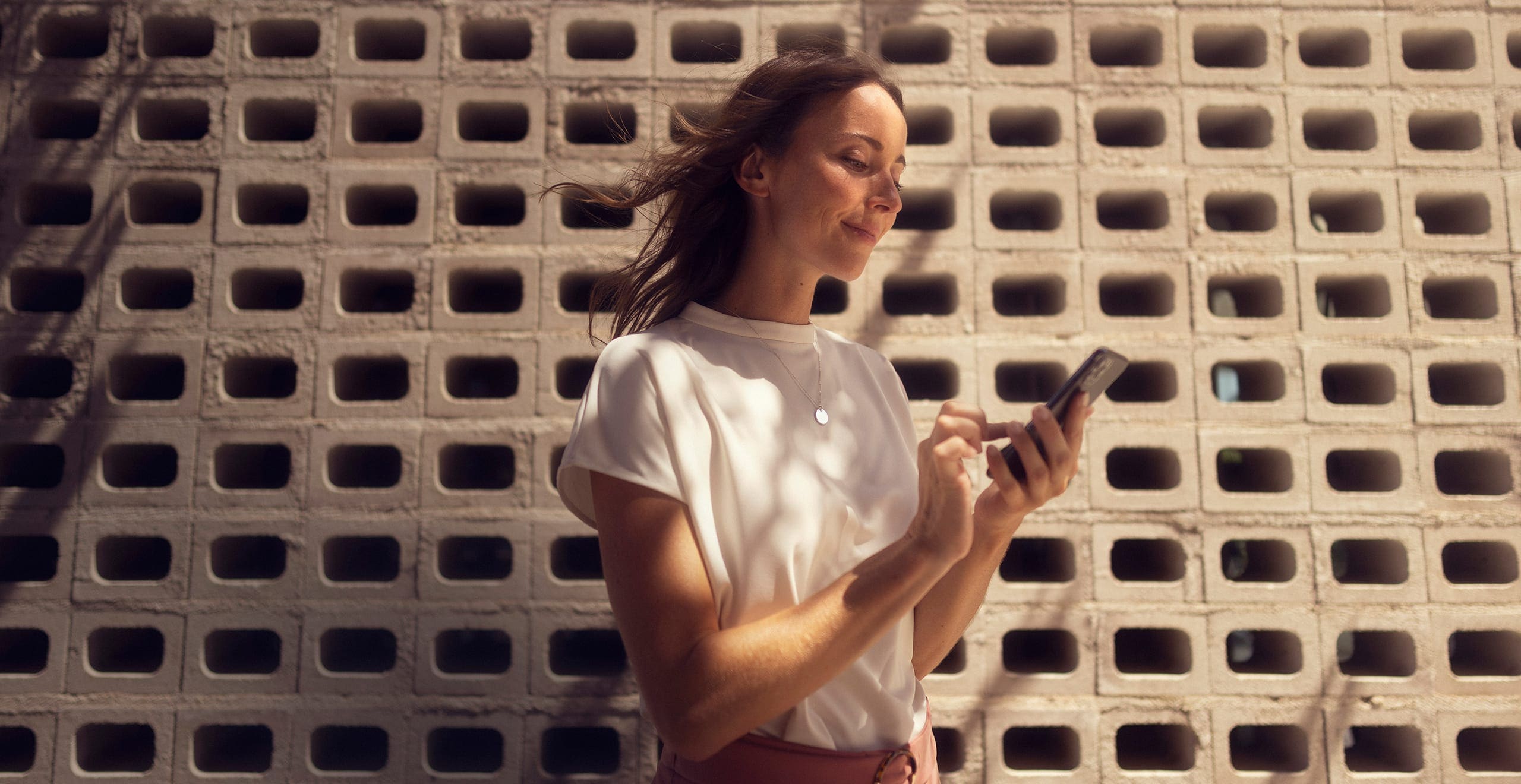 Woman with her smartphone connected to SEAT CONNECT