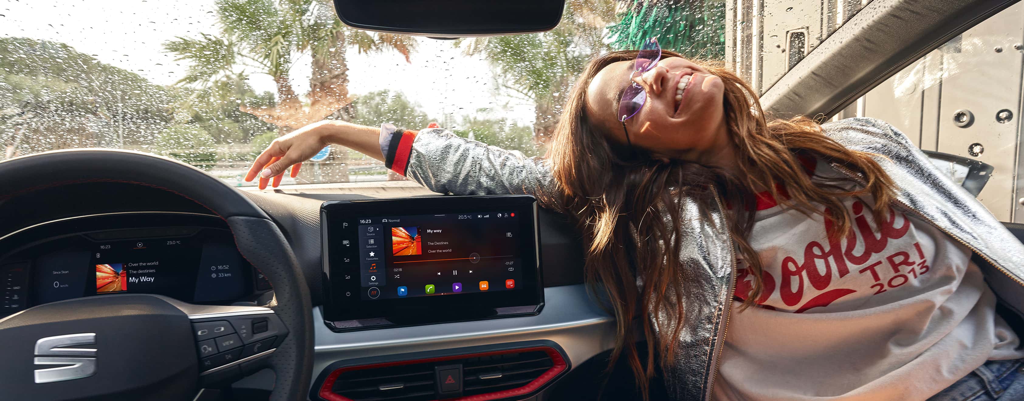 Woman sitting inside a SEAT Ibiza next to the 9.2" floating touchscreen