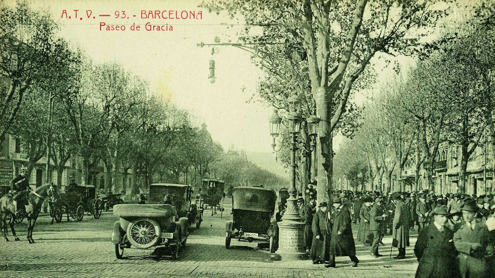 Pedestrians and horse drawn carriages on the street in Barcelona