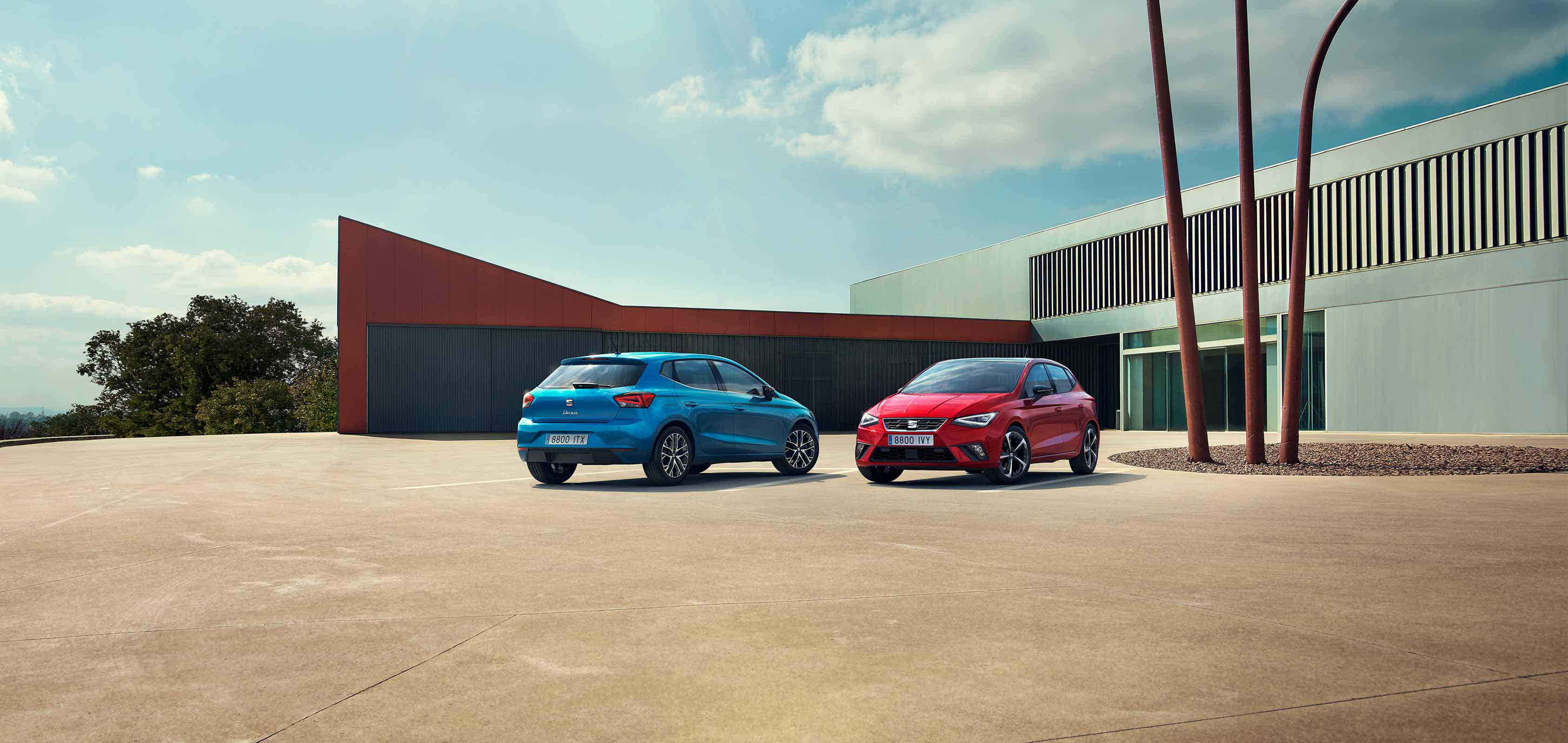 Two SEAT Ibiza parked, one Sapphire Blue colour and another Desire Red colour.