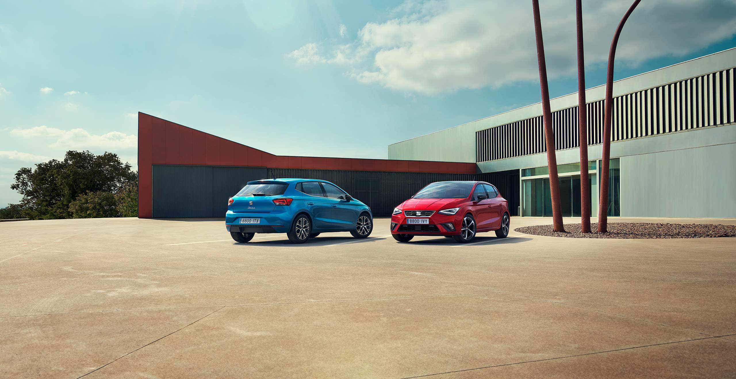 Two SEAT Ibiza parked, one Sapphire Blue colour and another Desire Red colour.