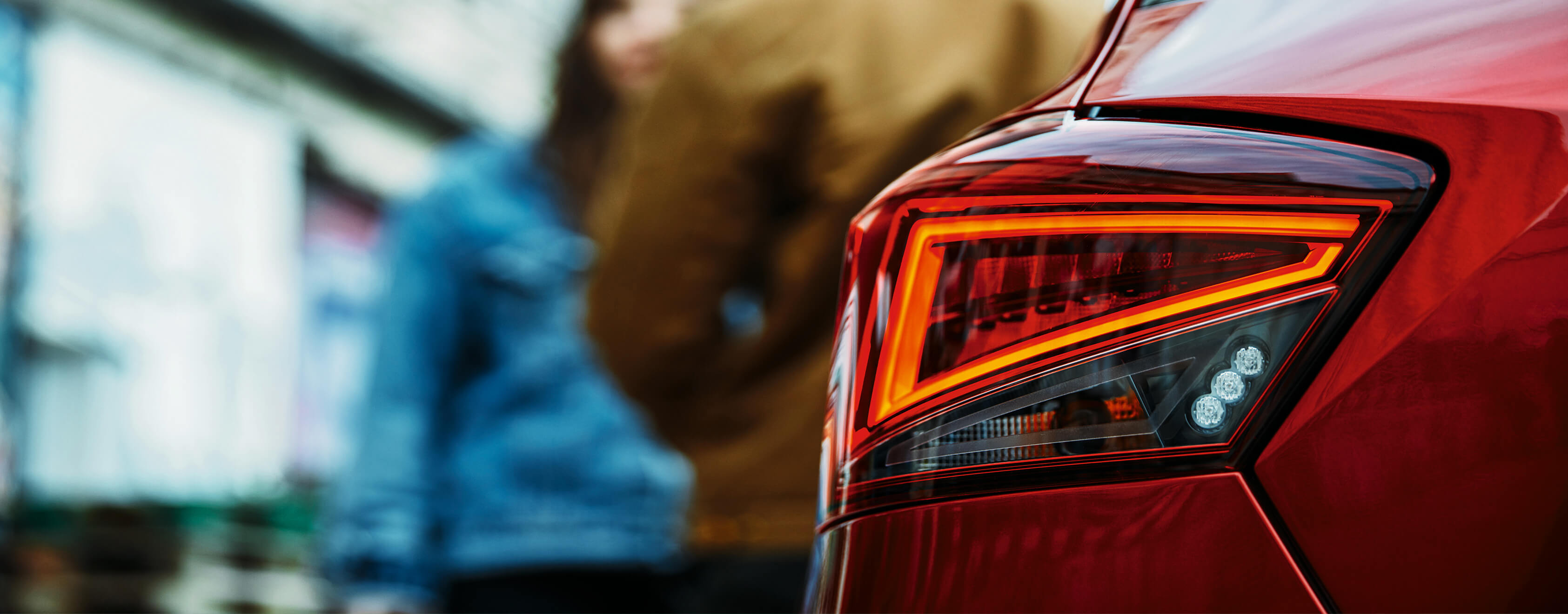 SEAT new car services warranty extension  maintenance – rear view of rear light with people in the background out of focus
